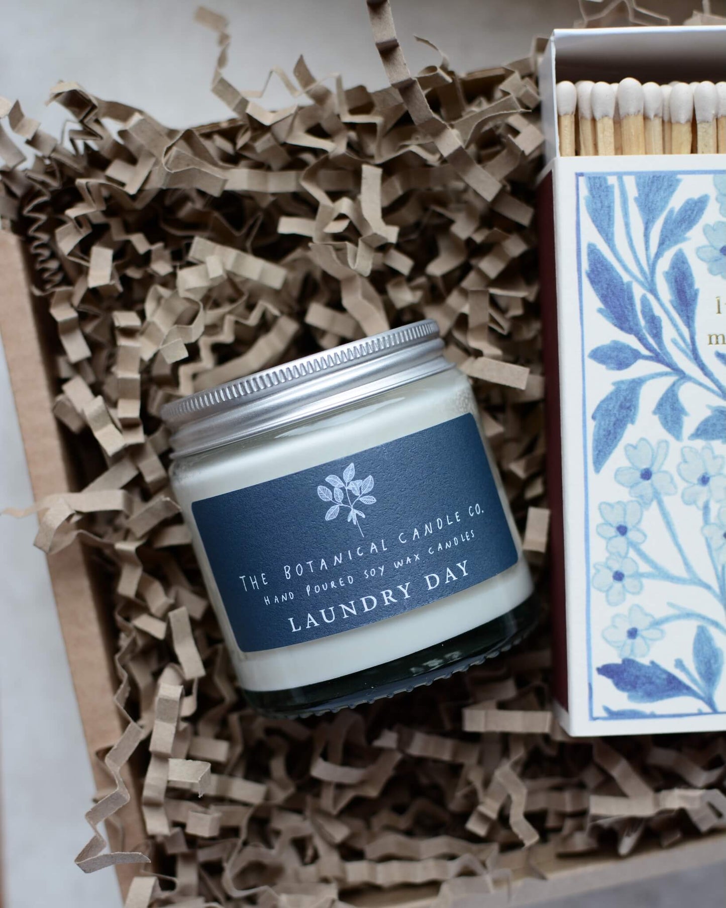 A detail shot of a blue and white themed candle gift box.