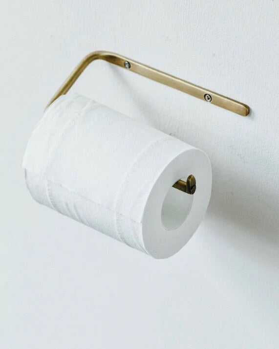 A solid brass toilet roll holder.
