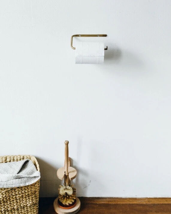 A solid brass toilet roll holder.