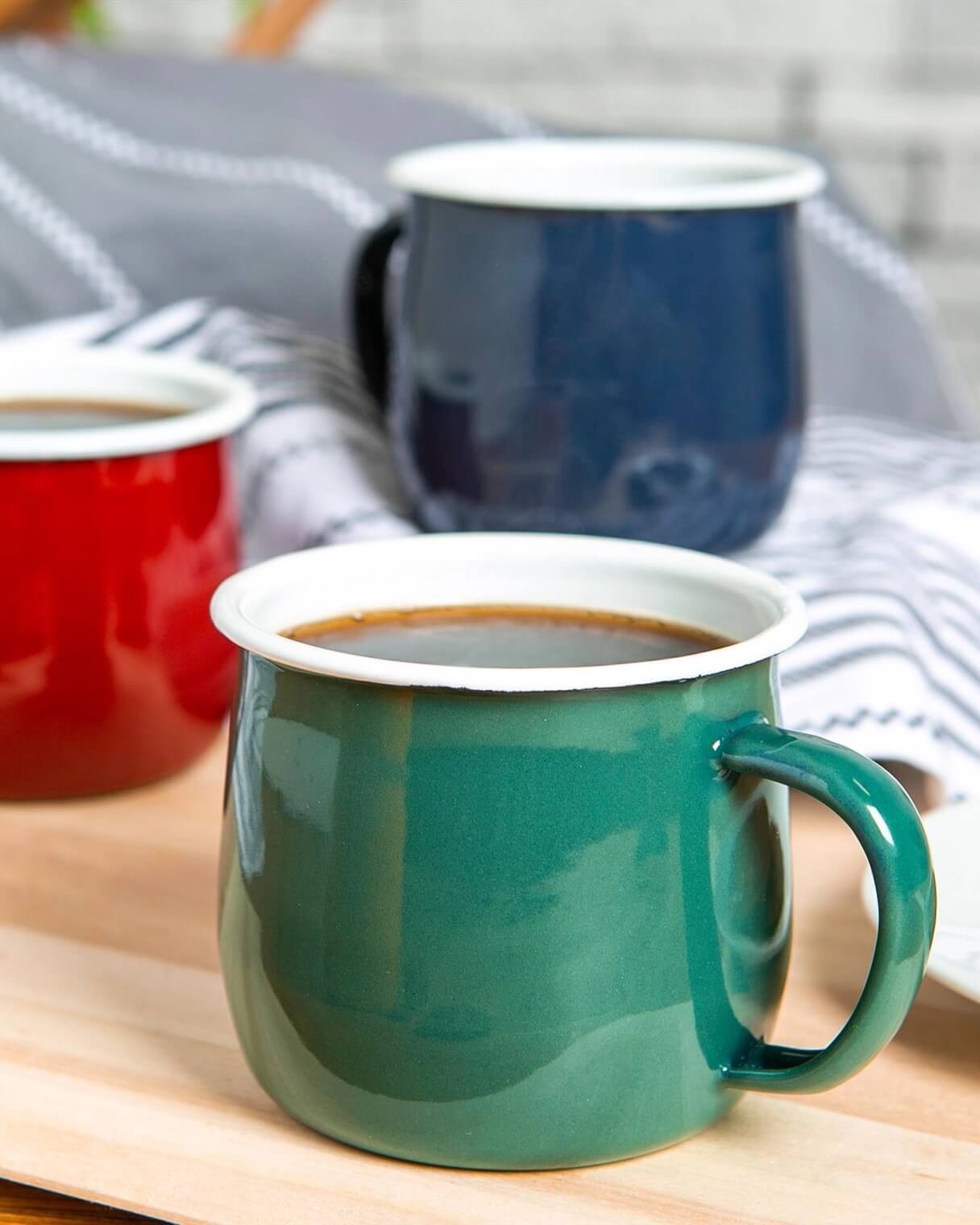 A collection of brightly coloured enamel mugs.