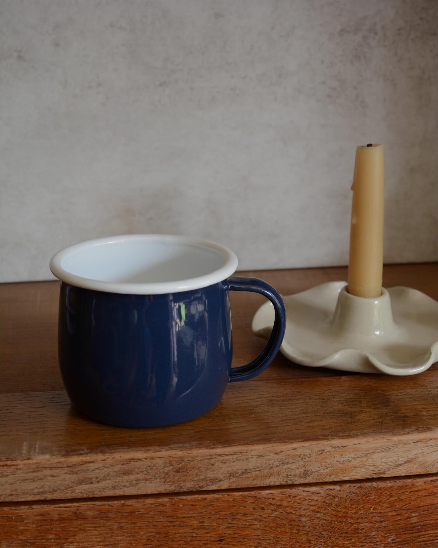 A navy blue enamel mug with white interior,