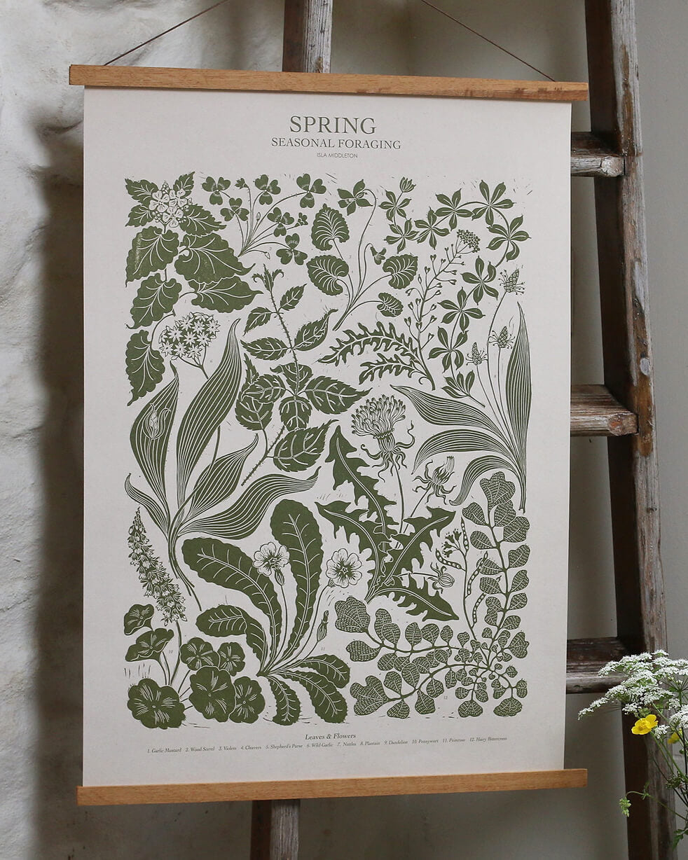 A green botanical print, depicting Spring plants. Displayed in an oak hanging frame.