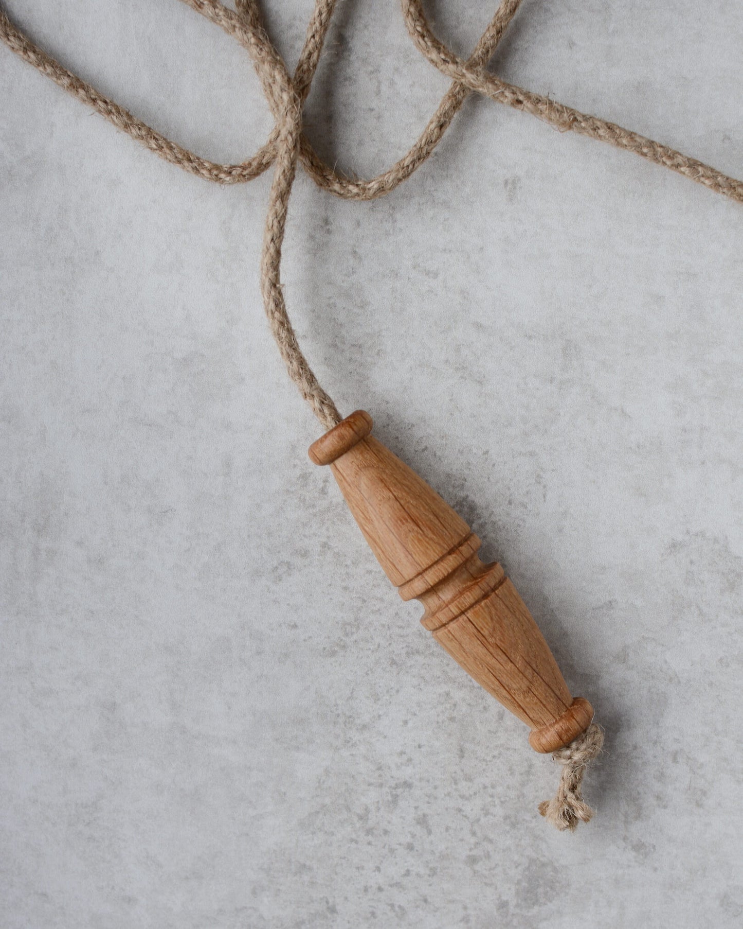 Oak toggle-style light pull with jute rope.