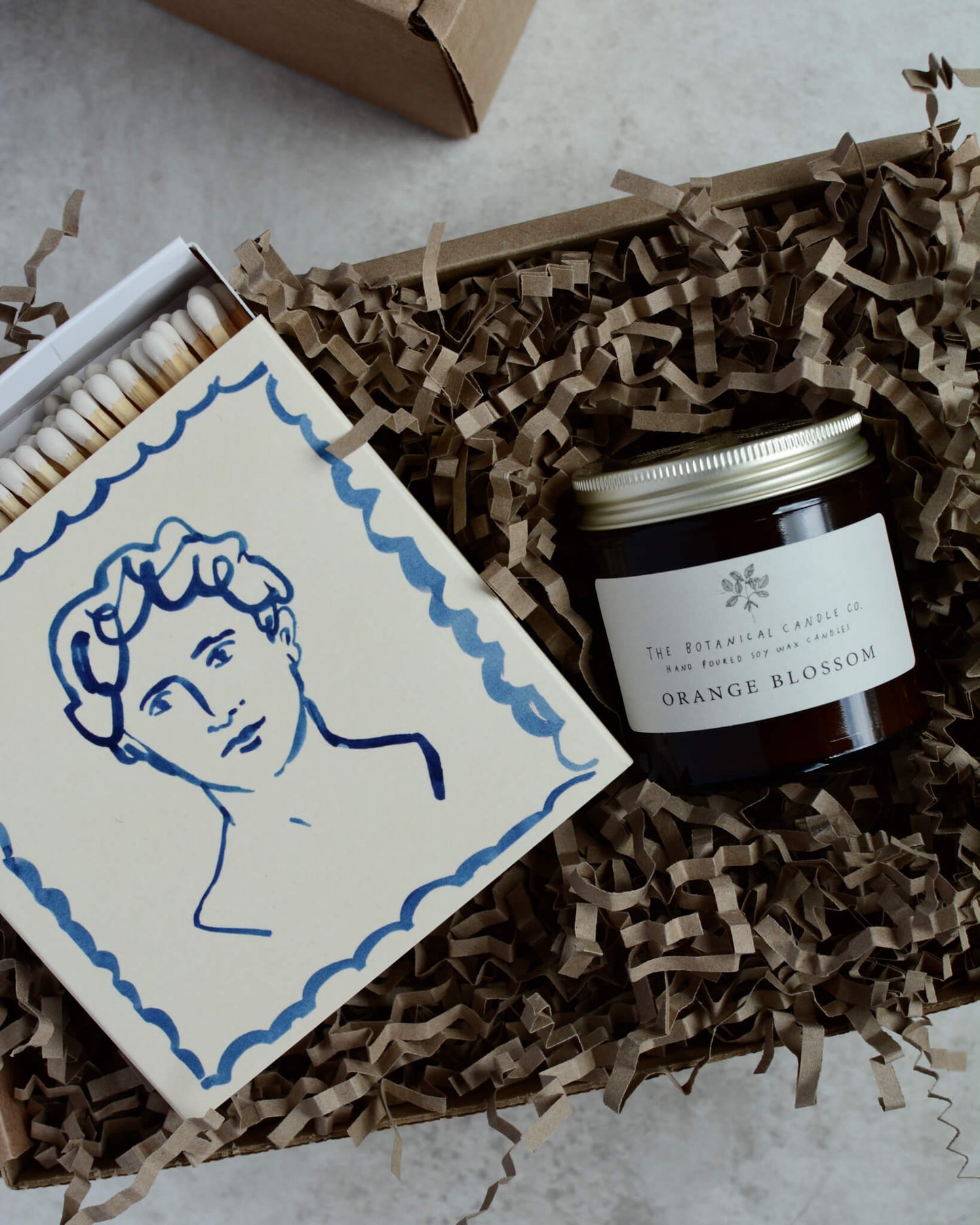 Orange Blossom scented soy wax candle by The Botanical Candle Co. in a gift box with matches.