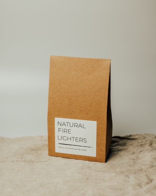 Brown paper packaging with 'Natural Fire Lighters' label on a textured surface.