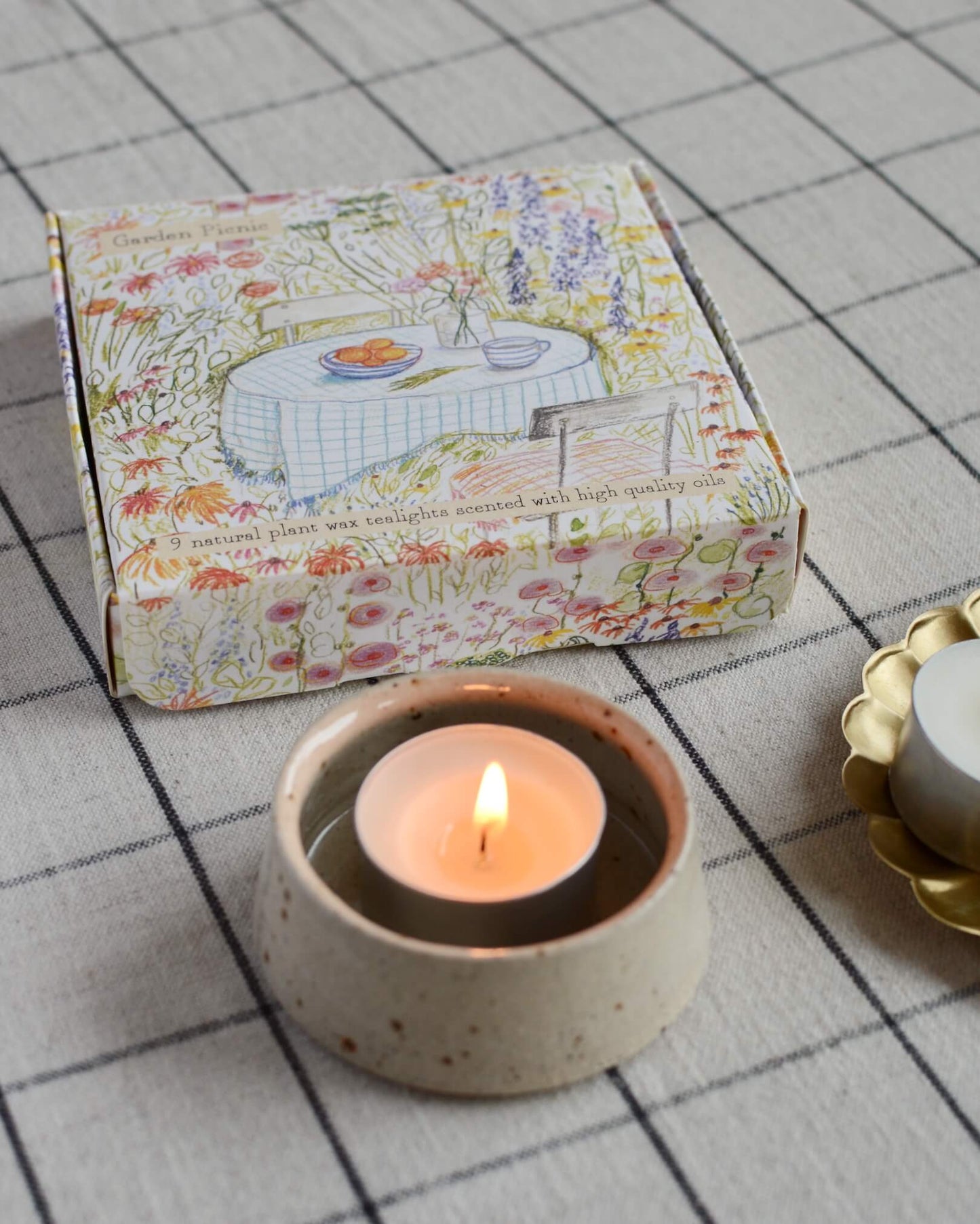 Garden Picnic scented tea lights with a hand-illustrated box design, depicting a summer garden.