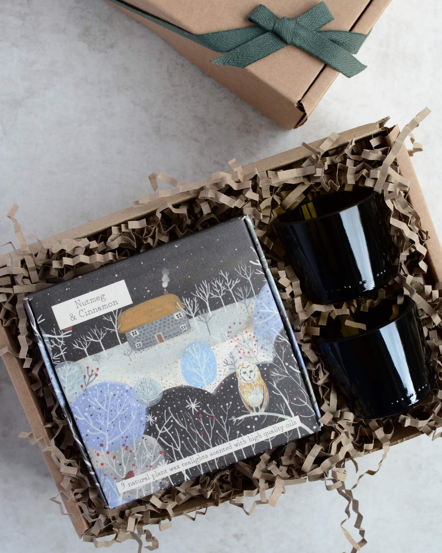 Gift set with a box of tealights and pair of green glass votives.