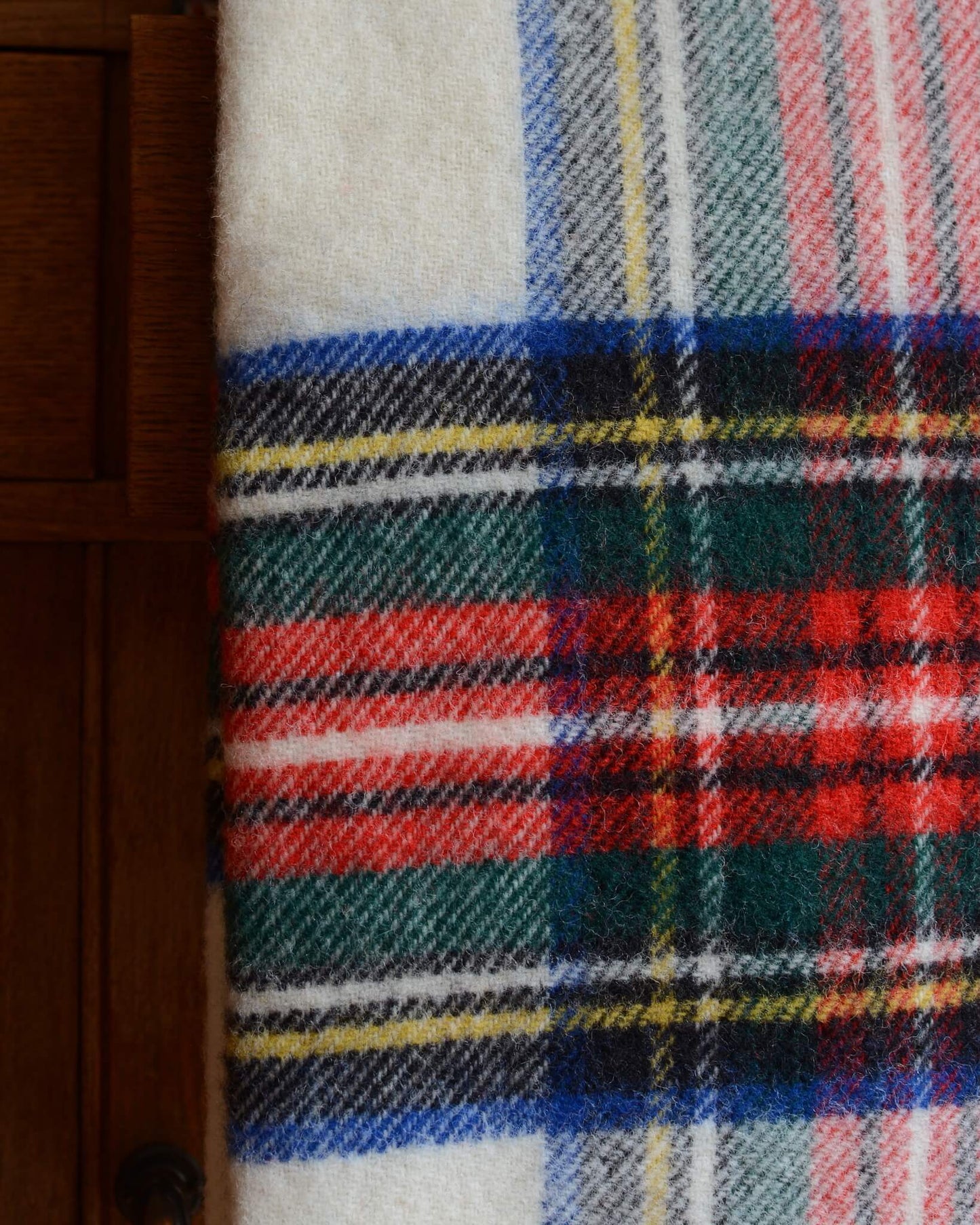 Close up of a plaid wool blanket with colourful pattern.