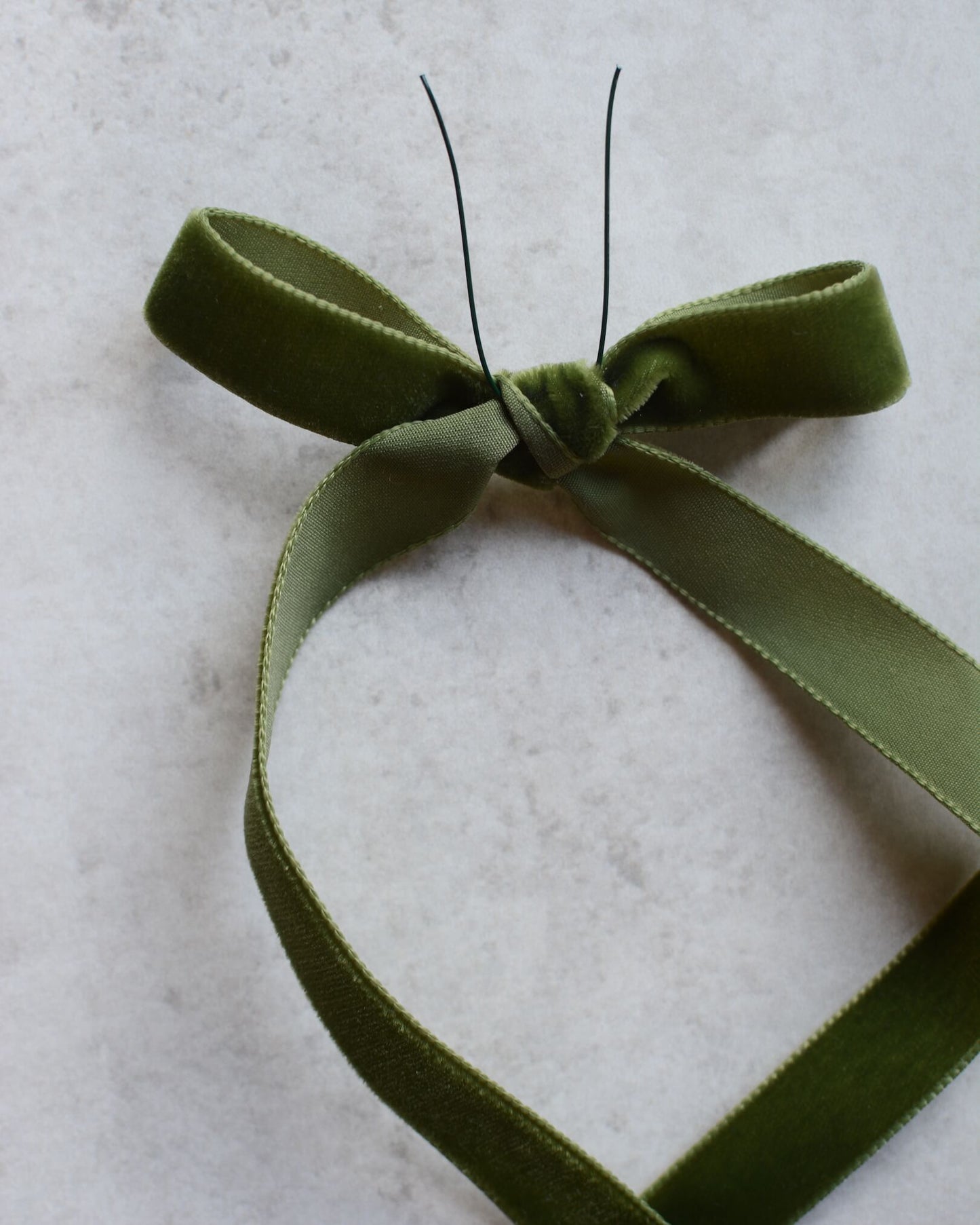 A green velvet ribbon bow.
