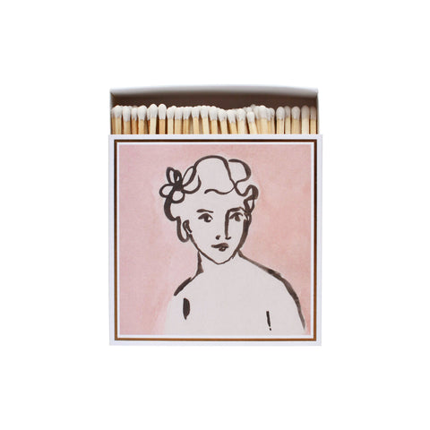 Pink matchbox featuring an illustrated portrait of a woman.