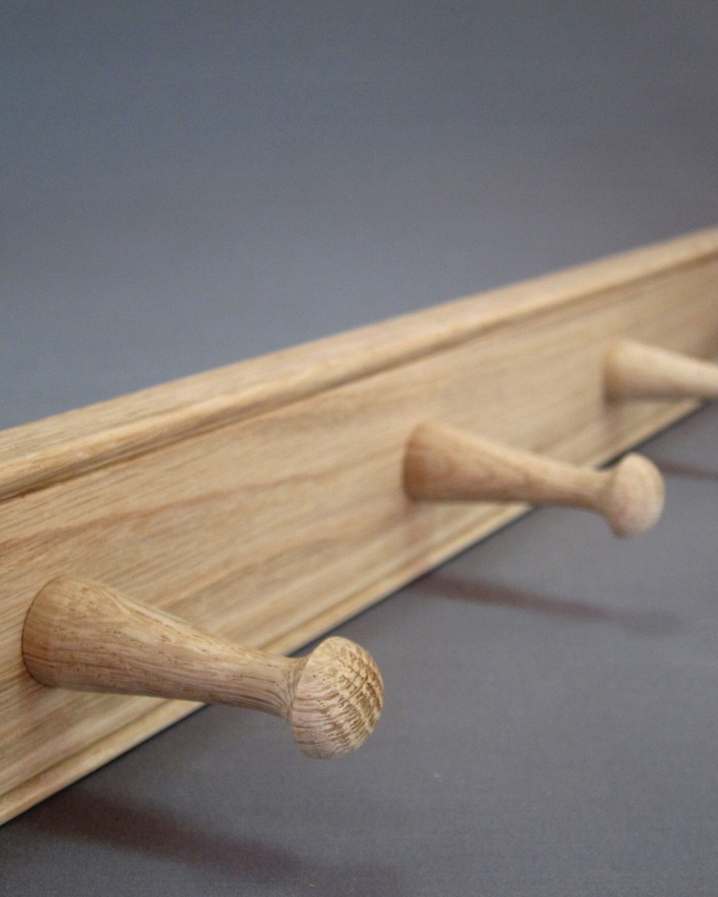 Detail of oak grain on a wooden peg rail by Creamore Mill