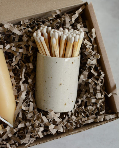 Close up of a ceramic match box, inside a candle gift box.