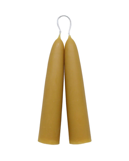Large stubby beeswax candles on a white background.