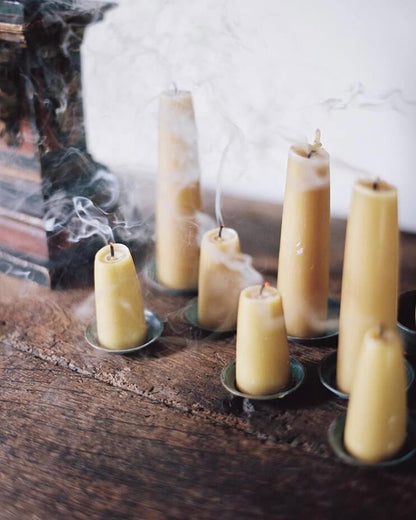 A collection of stubby beeswax candles.
