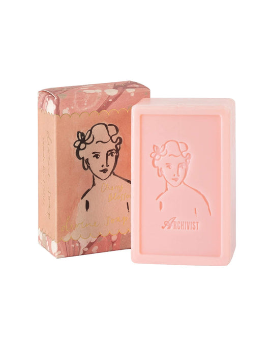 Pink soap bar and packaging with a vintage-style illustration on a white background
