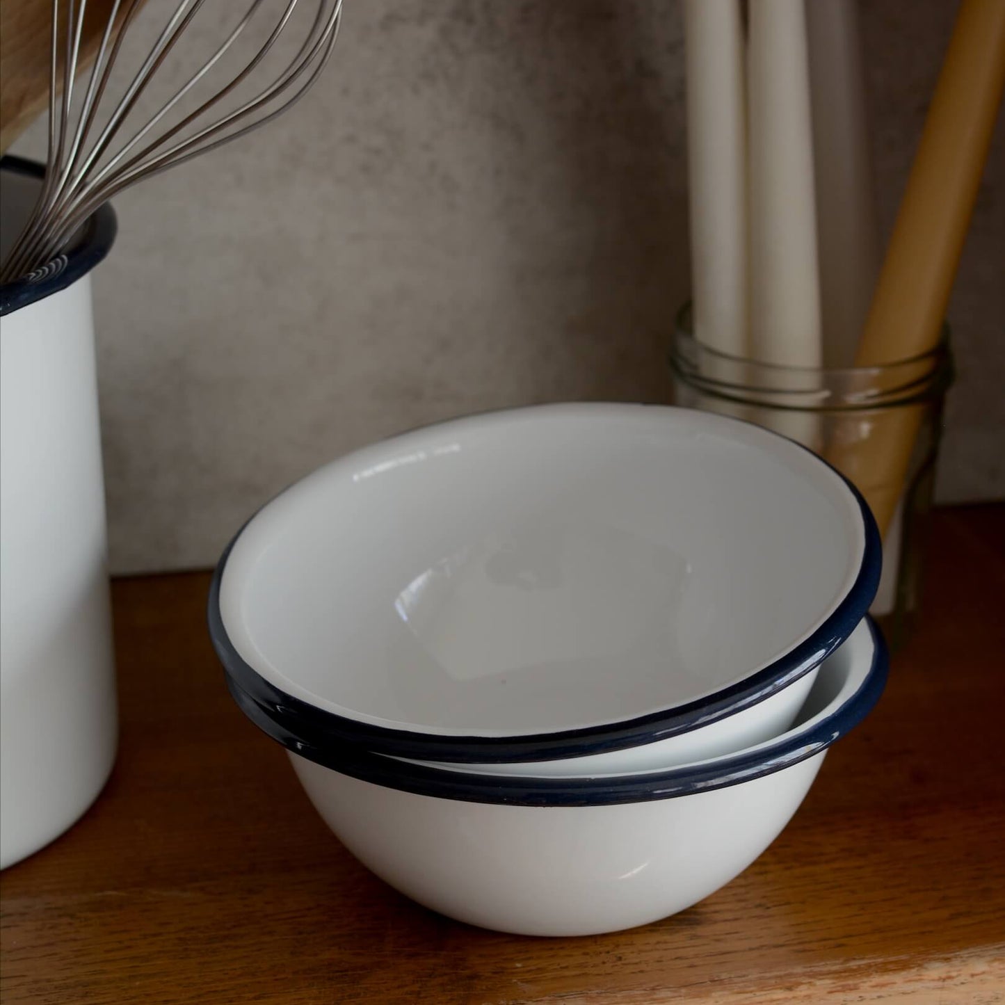 White and navy enamel bowls on a kitchen work surface.