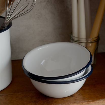 White and navy enamel bowls on a kitchen work surface.