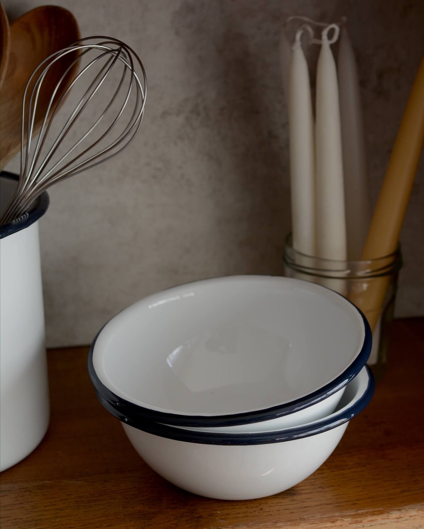 White and navy enamel bowls on a kitchen work surface.