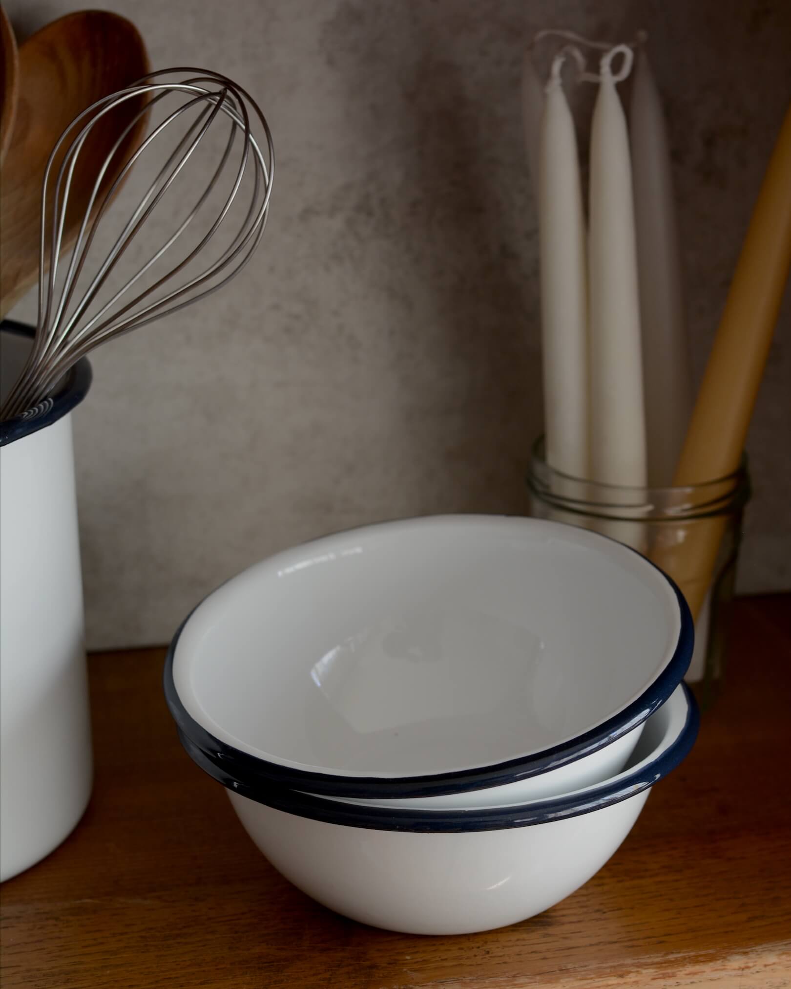 White and navy enamel bowls on a kitchen work surface.