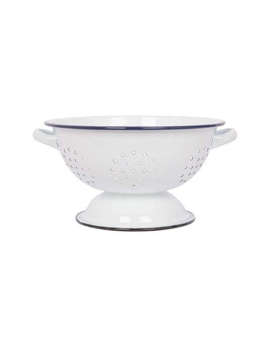 A classic white enamel kitchen colander with a navy blue rim. 