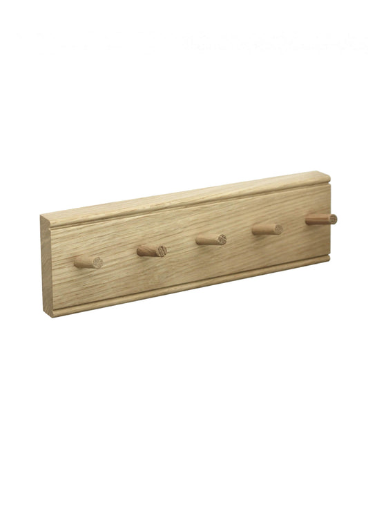 An oak key rack with 5 hooks by Creamore Mill, on a white background