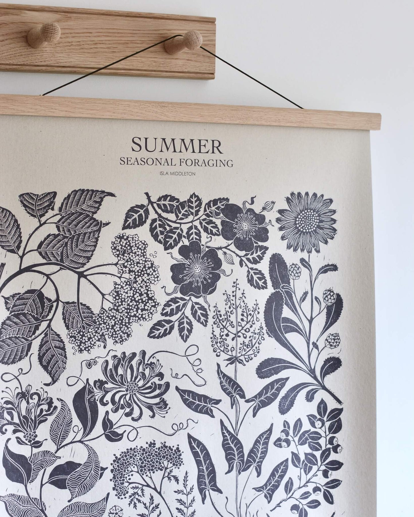 A botanical print, displayed hanging from a 4-peg oak shaker peg rail.