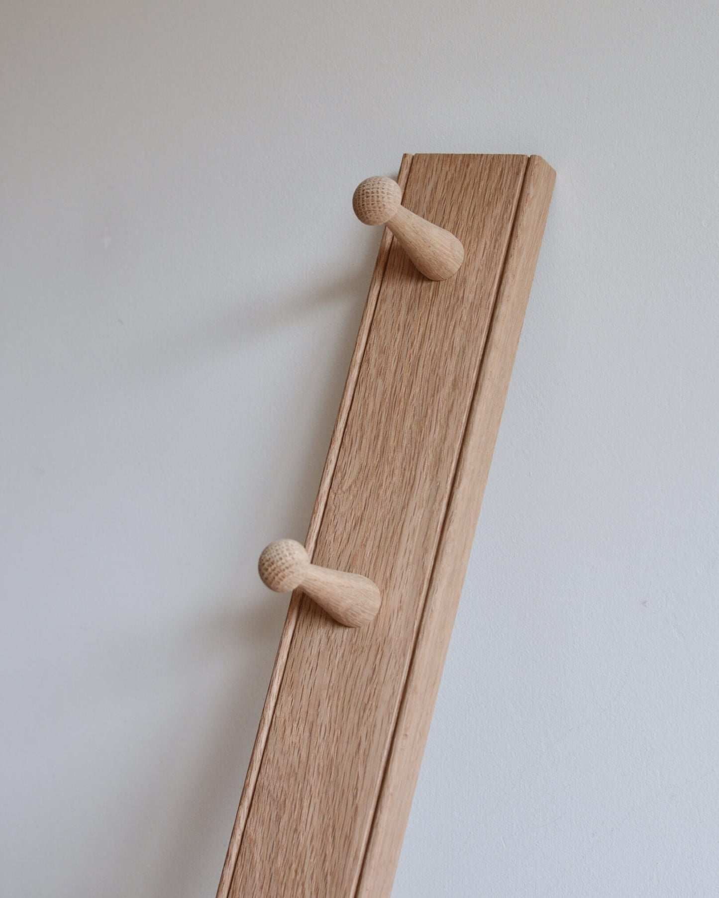A solid oak peg rail.