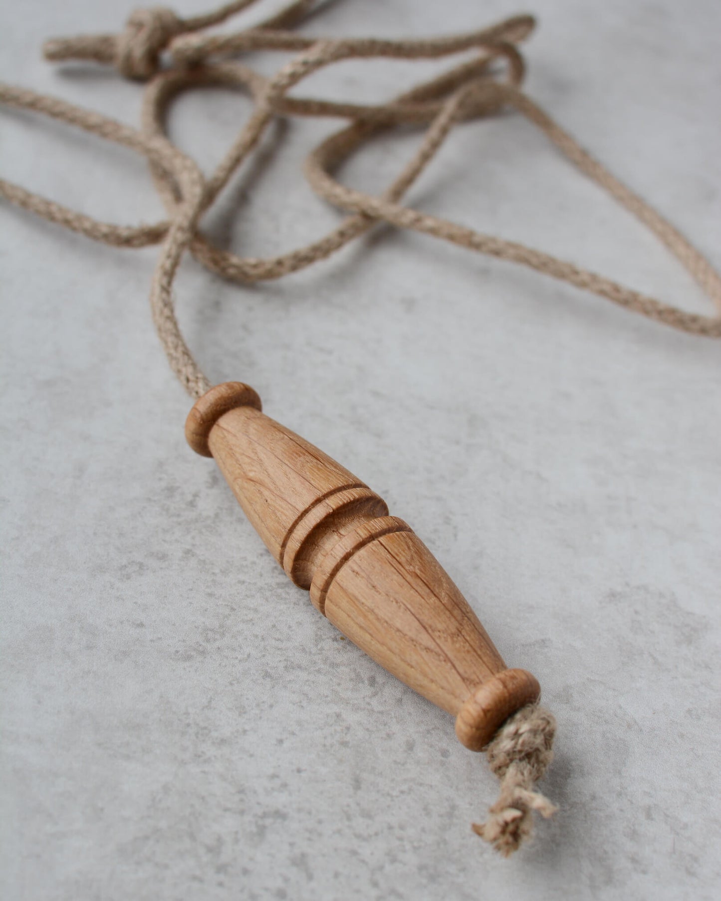 Oak toggle-style light pull with jute rope.