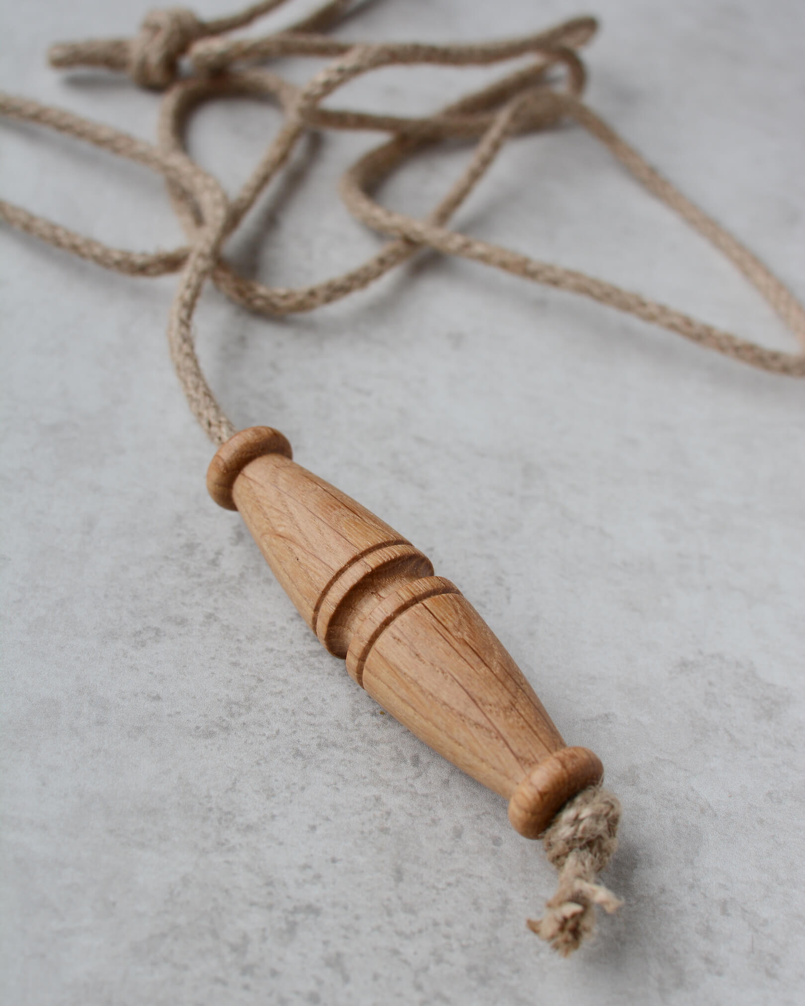 Oak toggle-style light pull with jute rope.