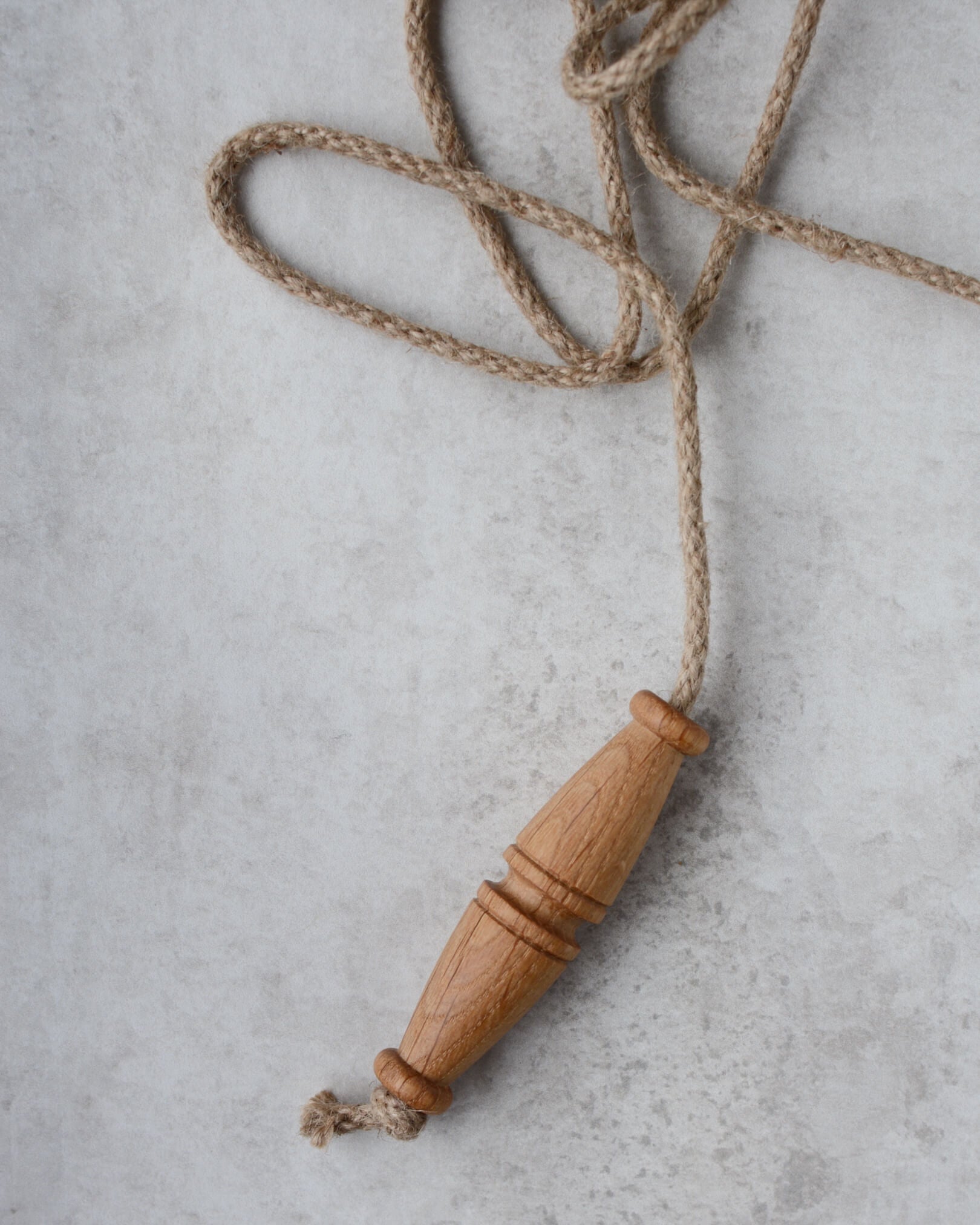 Oak toggle-style light pull with jute rope.