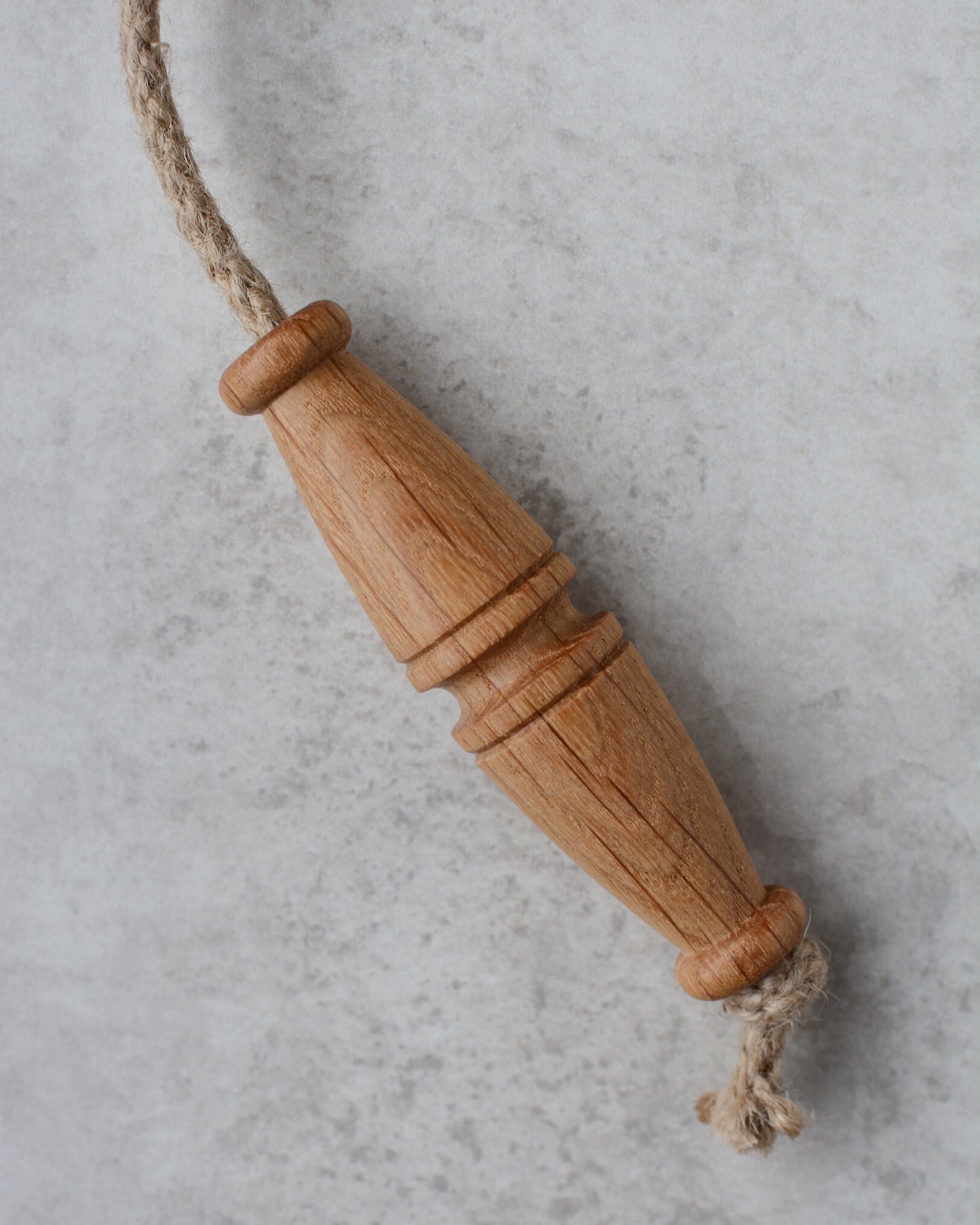 Oak toggle-style light pull with jute rope.