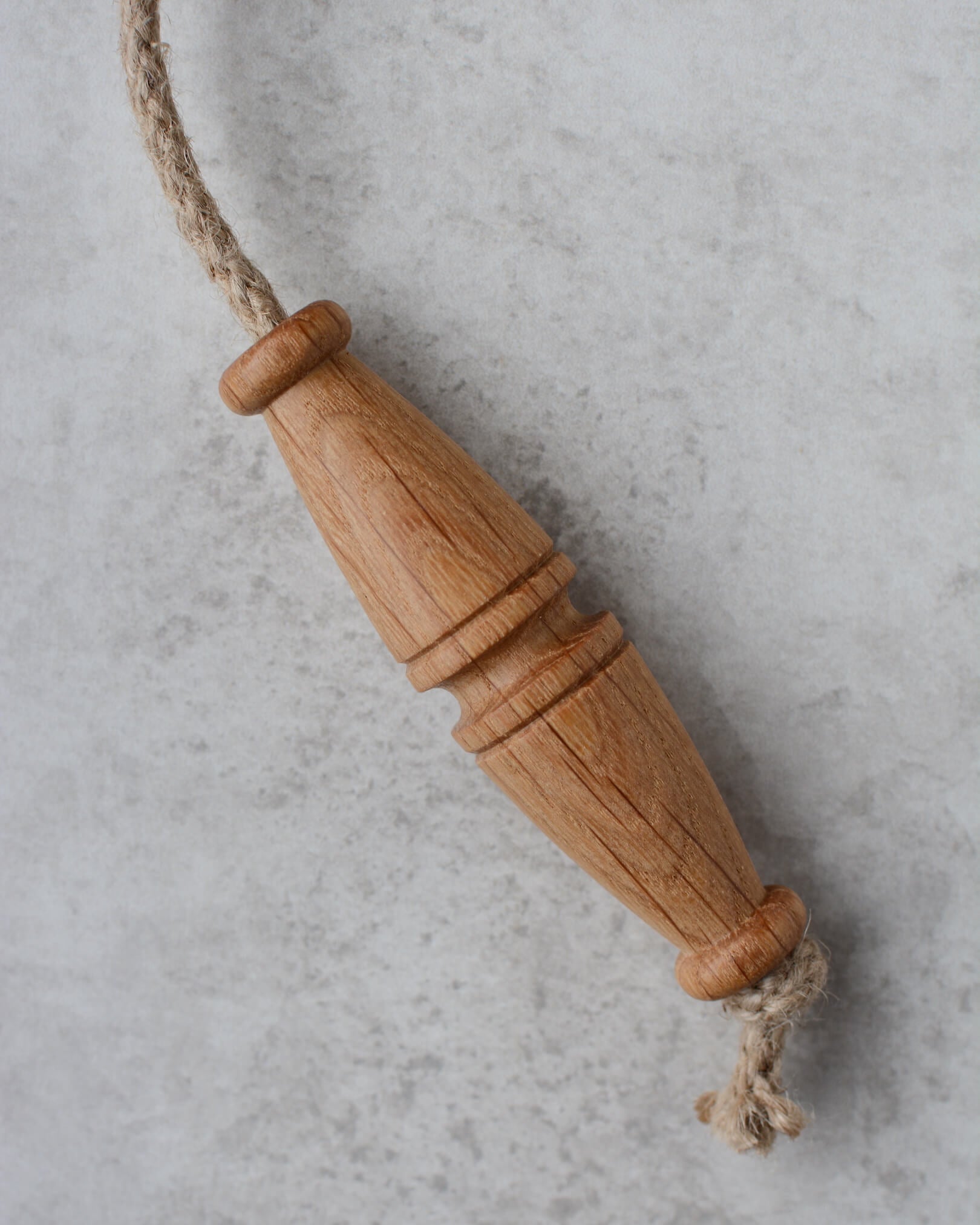 Oak toggle-style light pull with jute rope.