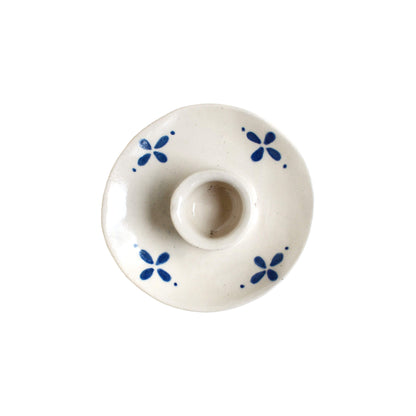 White and blue ceramic candle holder on a white background.