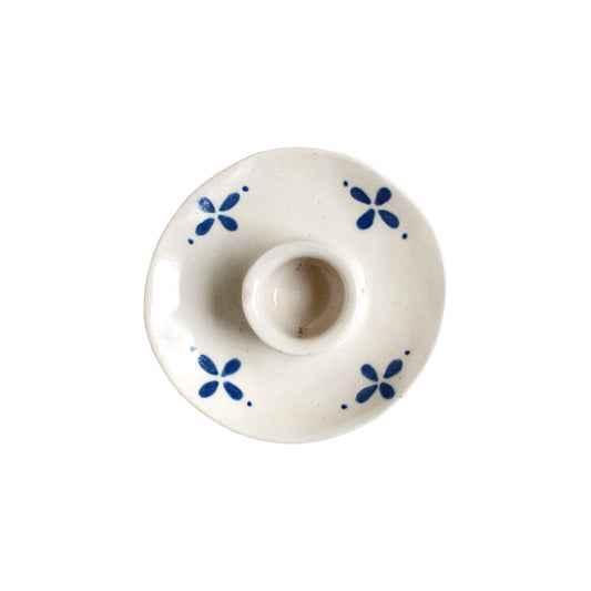 White and blue ceramic candle holder on a white background.