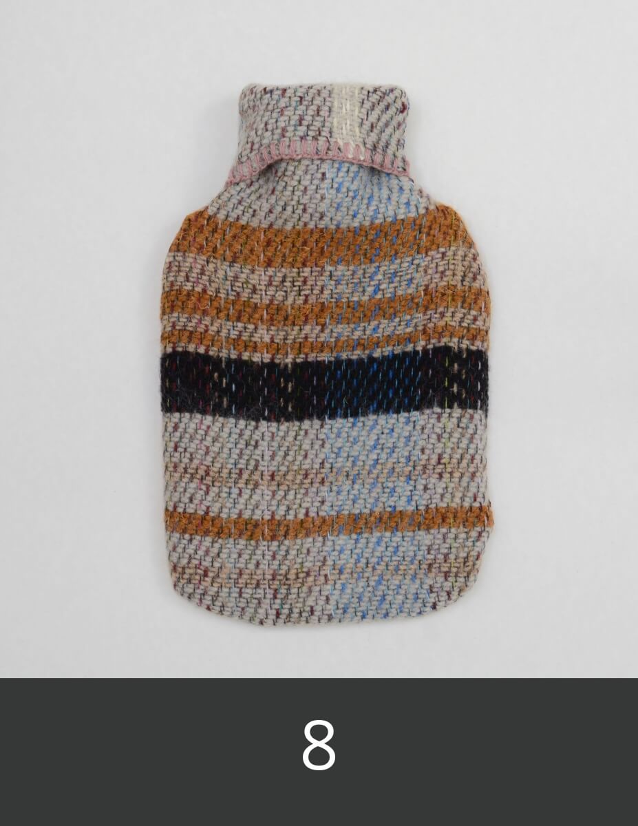 Knitted woollen hot water bottle cover with multicolour stripes.
