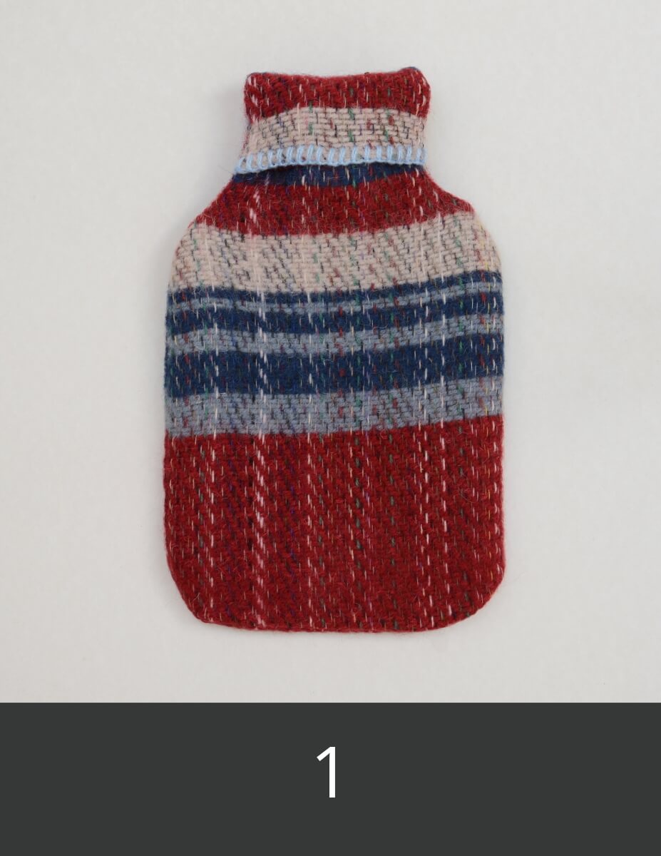 Textured red, blue, and white hot water bottle cover.
