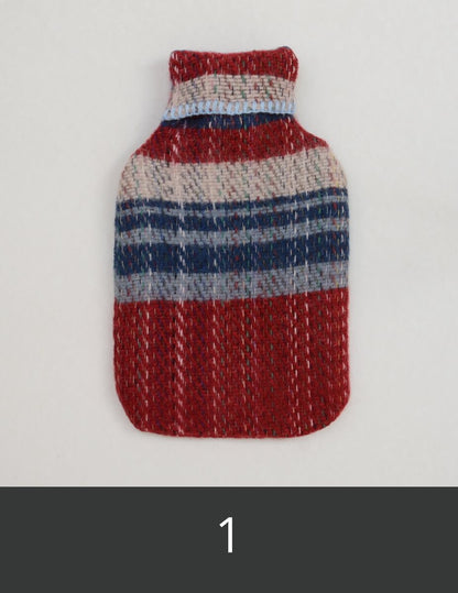 Textured red, blue, and white hot water bottle cover.