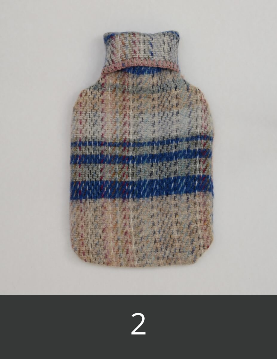 Woollen hot water bottle cover with blue and grey stripes.