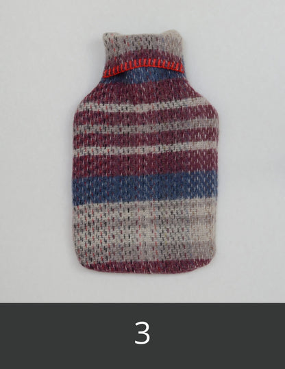 Wool hot water bottle cover with burgundy, pale grey and blue stripes.