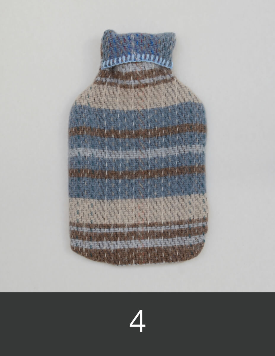 Wool hot water bottle with blue, brown, and beige stripes.