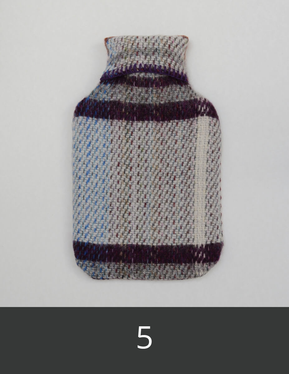 Wool hot water bottle cover with aubergine, pale grey and ark grey pattern.