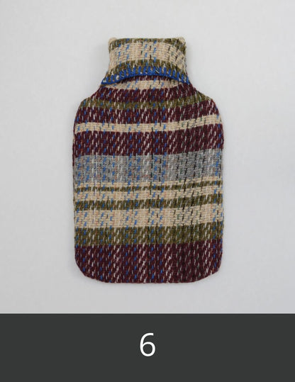 Multicoloured textured hot water bottle cover.