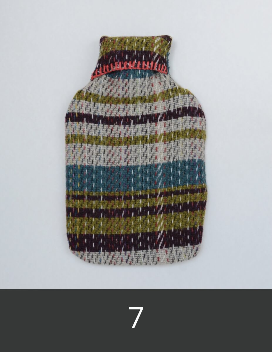 Recycled wool hot water bottle cover with turquoise, green and white stripes.
