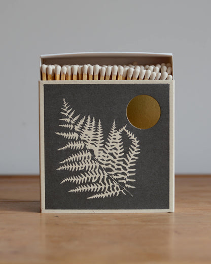 A box of letterpress matches, featuring an illustration of a fern leaf.
