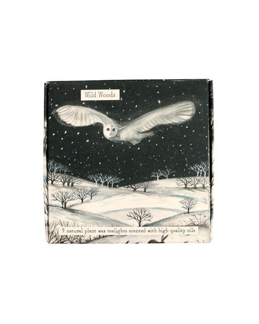 Pack of tea light candles with a design of an owl flying over a snowy landscape, labelled 'Wild Woods'.