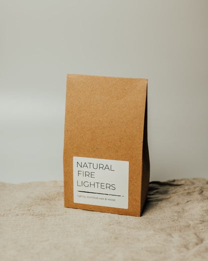 Brown paper packaging with 'Natural Fire Lighters' label on a textured surface.