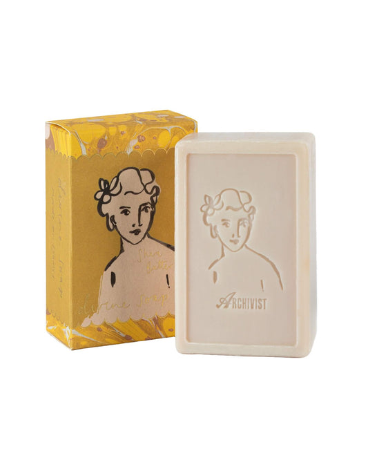 Bar of soap with 'Archivist' branding next to its packaging on a white background