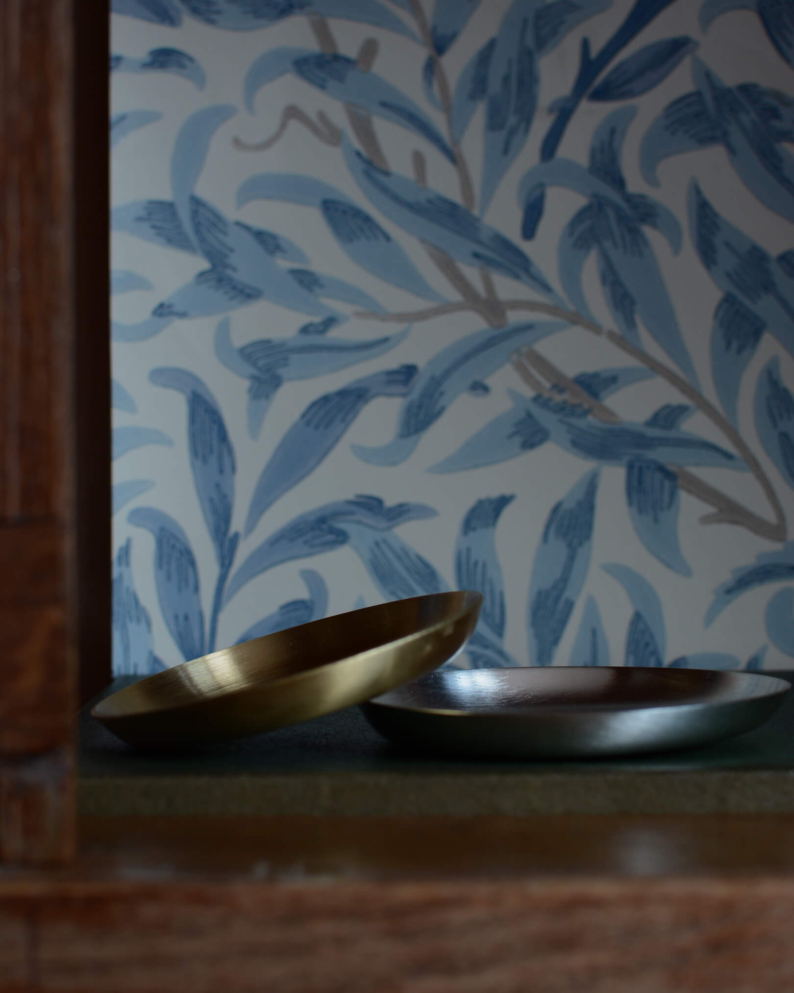 A set of 2 silver and brass candle dishes.