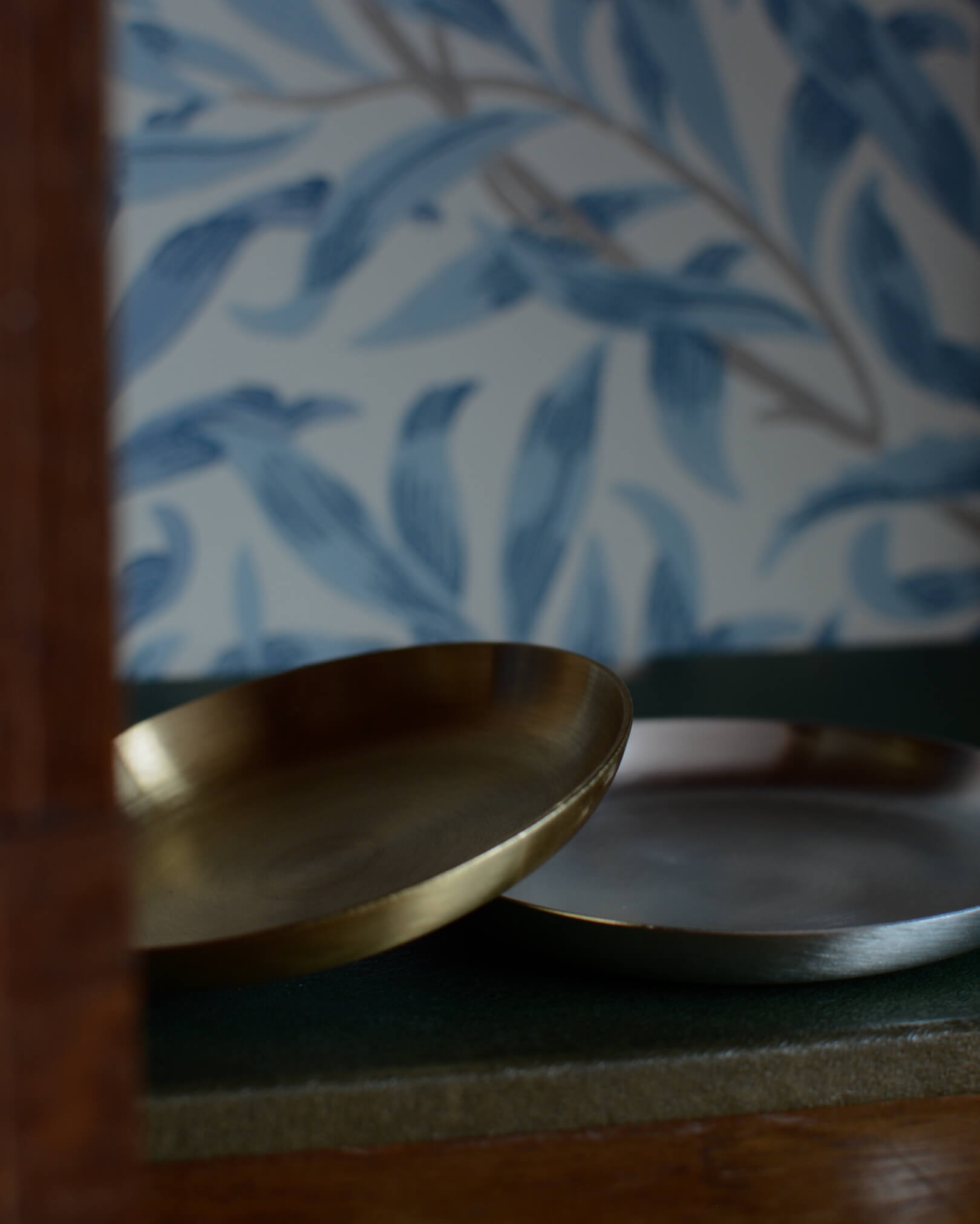A set of 2 silver and brass candle dishes.