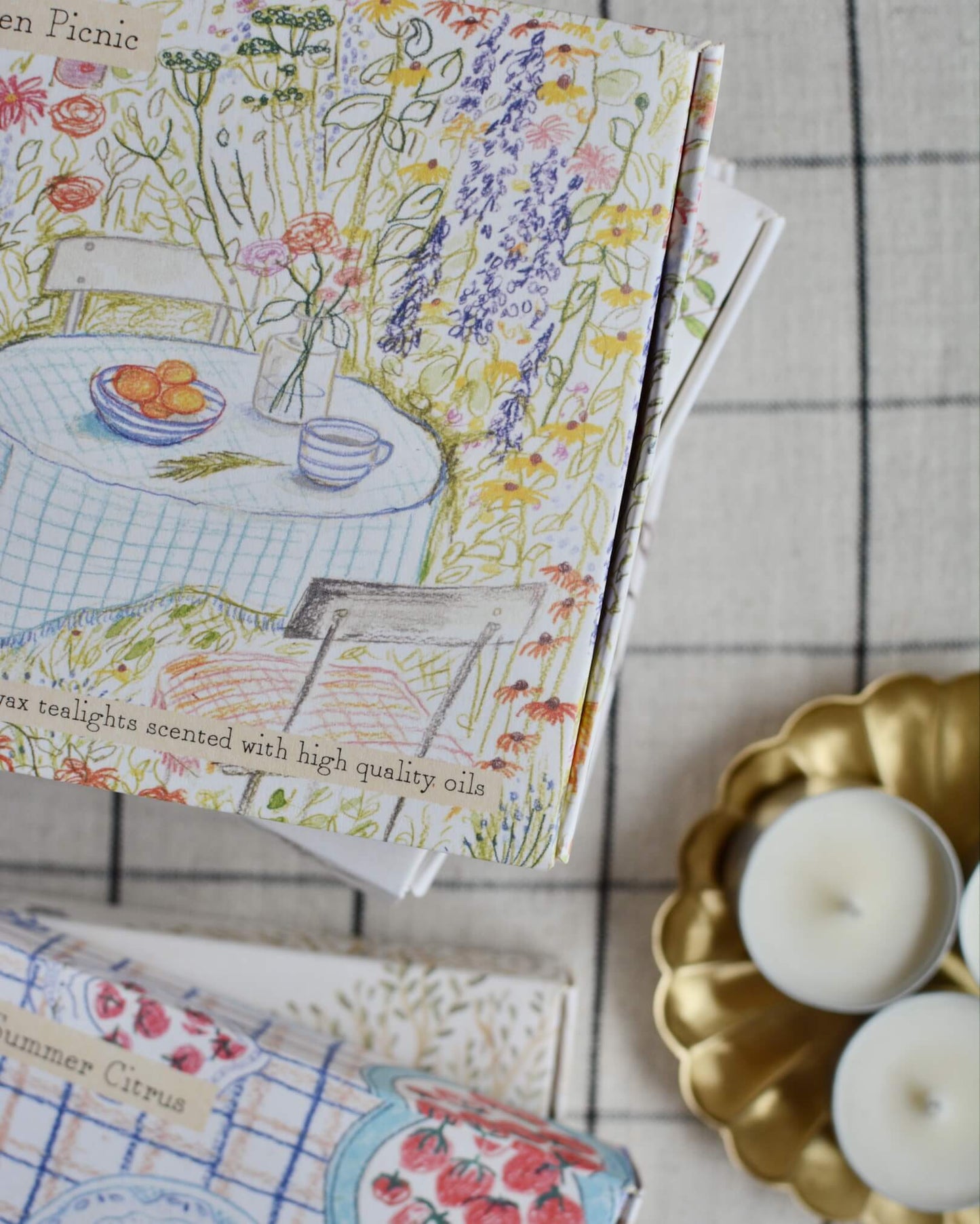 Garden Picnic scented tea lights with a hand-illustrated box design, depicting a summer garden.